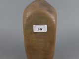 a brown vase with a white label on it