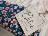 a blue and white blanket with pink flowers on it