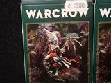 two boxes of warcraw cards sitting on top of a table