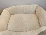 a dog bed on the floor in the corner of the room