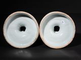 pair of blue and white porcelain vases on a black surface