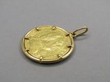 a close up of a gold coin with a face on it