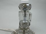 a glass lamp that is sitting on a table