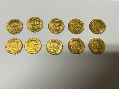 a bunch of gold coins sitting on top of a white table