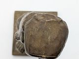 a rock that is sitting on top of a piece of metal