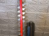a red pipe sticking out of a wall next to a radiator