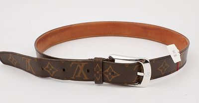 a close up of a brown belt with a silver buckle