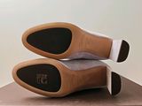 pair of shoes on top of a box on a table
