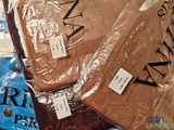 many bags of clothing that are on a table