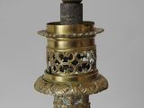an image of a brass vase with a candle holder on top of it