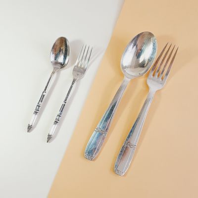 two forks and two spoons sitting on a table