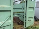 a green gate that is open on the side of a trailer