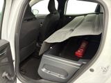 a car with a surfboard in the back of it ' s trunk