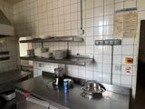 a kitchen with a stove, sink, and dishwasher in it