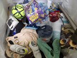 a white bag filled with various items that include shoes, socks, and other items