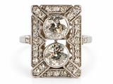 an art deco diamond ring with two round diamonds in the center