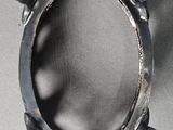 a picture of a silver ring that is on a table