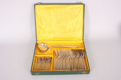 a green case with silverware in it on a white surface