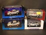 three toy cars are sitting in boxes on a black surface