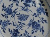 a blue and white plate with blue flowers on it