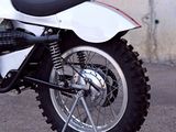 a white and black motorcycle parked in a parking lot