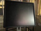 a computer monitor sitting on a table in a room