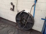 a hose on the ground next to a wall