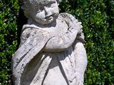 a statue of a boy holding a baby in his arms