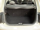 the back of a white car with the trunk open and the seats down