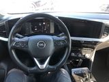 the interior of a car with a steering wheel and dashboard controls