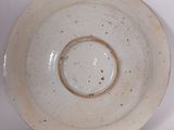 a white bowl with a brown rim sitting on a table