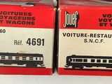 two boxes of miniature trains on display on a table