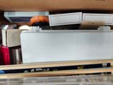 a white refrigerator sitting inside of a box filled with assorted items
