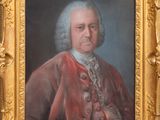 an old painting of a man in a red coat with a gold frame