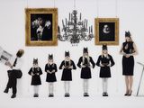 a group of people dressed up in costumes standing in front of pictures