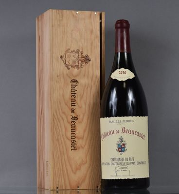 a bottle of wine sitting next to a wooden box