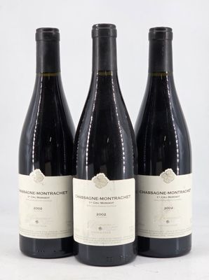 three bottles of wine sitting on top of a white table