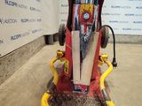 a red and yellow snowmobile that is sitting on the ground