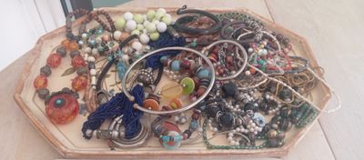 a tray with many different types of jewelry on it