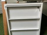 a white desk with a drawer underneath it