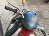 a blue and red scooter with a mirror on top of it