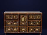 an antique chest of drawers with a decorative design on the front
