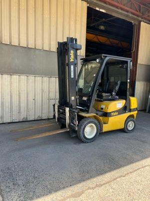 a forklift parked in front of a building