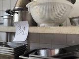 many pots and pans on the counter in the kitchen