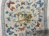 blue and orange butterflies on a white square with a blue border
