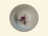 a small white bowl with a pink rose on it