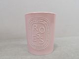 a pink cup with a logo on it sitting on a table