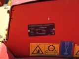 a close up of a red machine with a sign on it