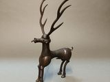 bronze statue of a deer with antlers on a white background