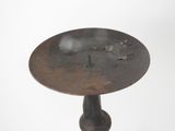 a small metal candle holder on a white background